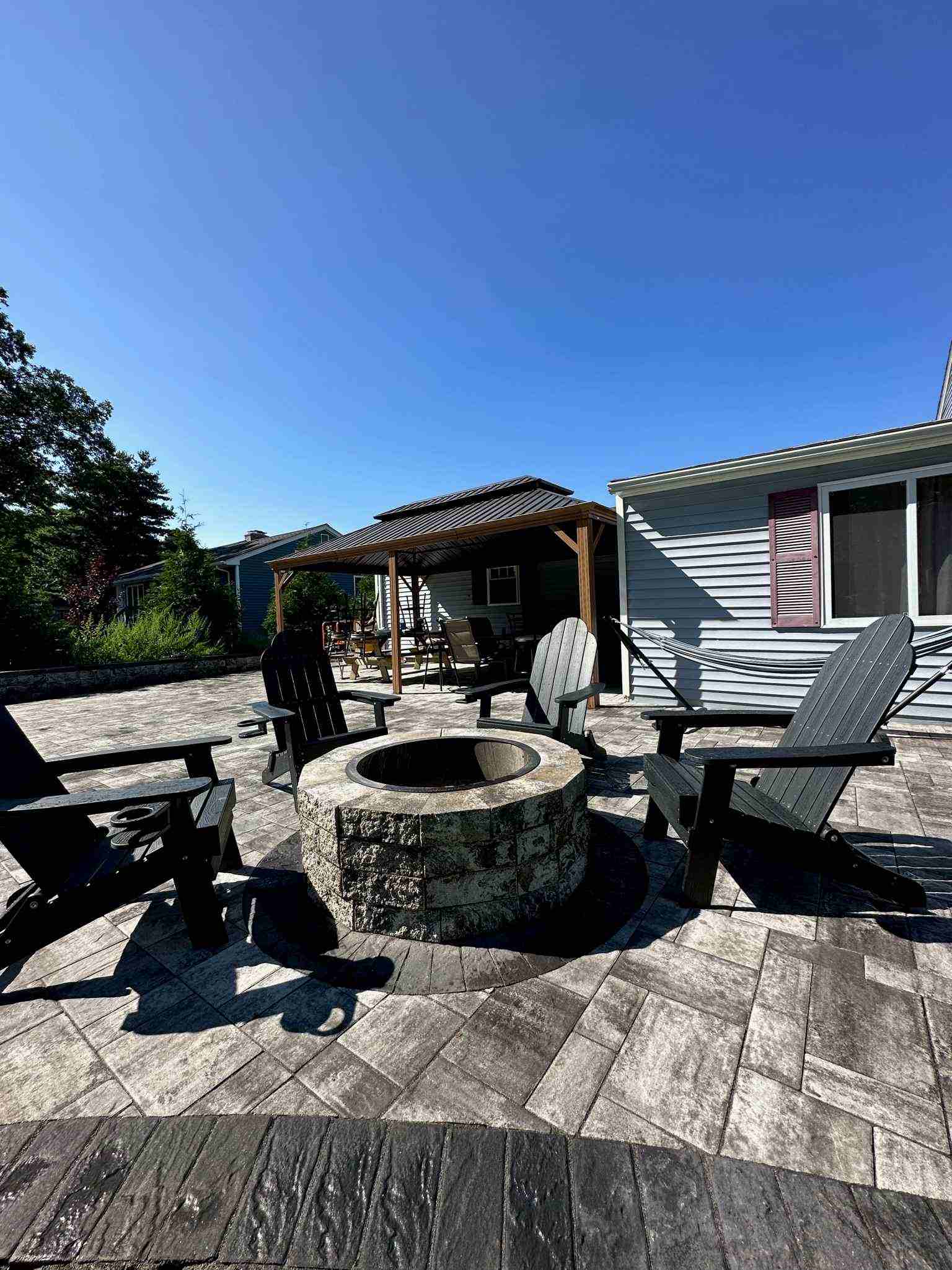 A beautiful circular stone patio, perfect for gatherings, at a home in Massachusetts.