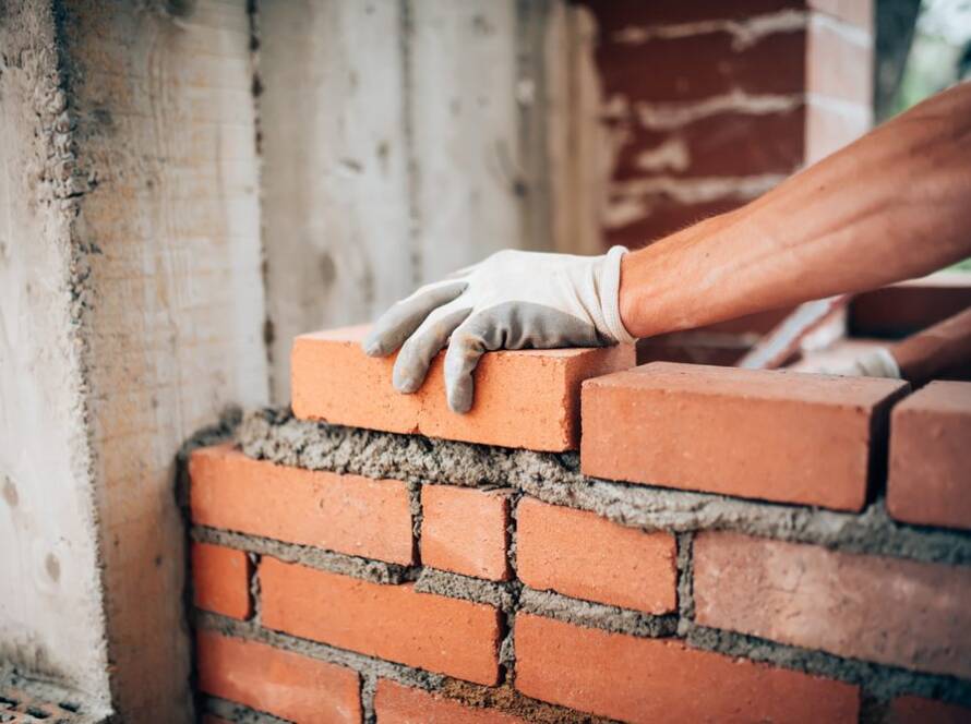 Professional brick mason building structural wall in Massachusetts