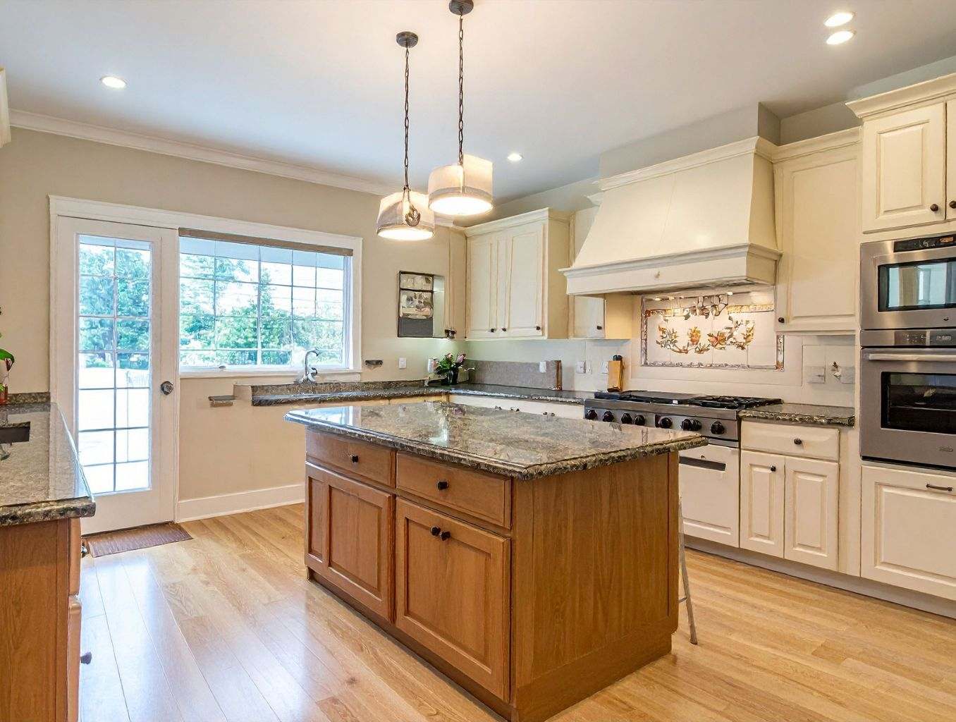 A vibrant, artful kitchen backsplash that serves as the centerpiece of the room.
