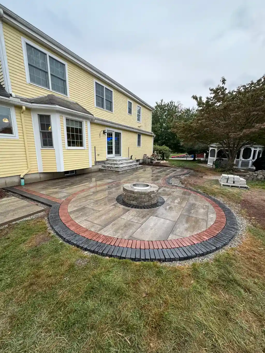 Custom patio with a fire pit
