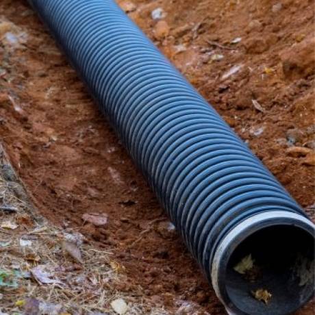 Effective-Drainage-Dry-Well-Systems-Protect-Your-Foundatio Installing French drain system in Massachusetts residential yard